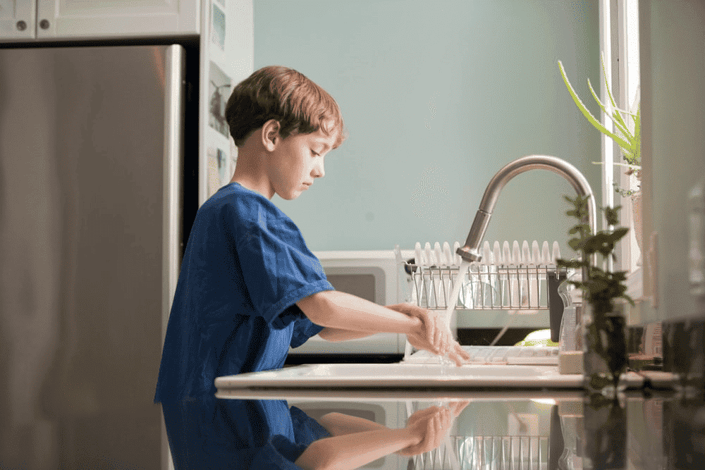 A Boy Washing His Hands